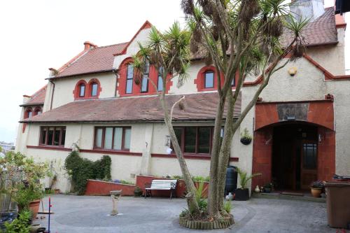 a house with two palm trees in front of it at Victoria House in Barrow in Furness