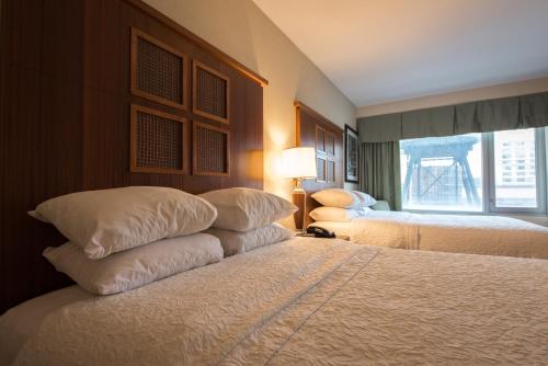 a hotel room with two beds and a window at SoHo 54 in New York