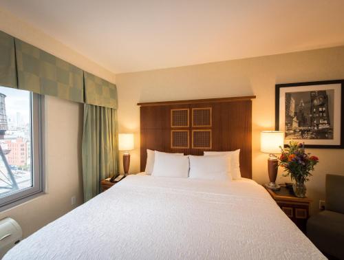 a hotel room with a large bed and a window at SoHo 54 in New York