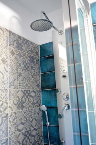 a bathroom with a shower with a glass door at Villa Petra in Kamilari