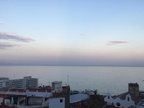 a view of the ocean from the roofs of buildings at Nogalera Beach Apartment in Torremolinos