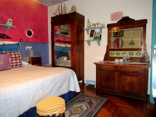 a bedroom with a bed and a dresser and a mirror at Art B&B La Casa del Pittore in Revine Lago