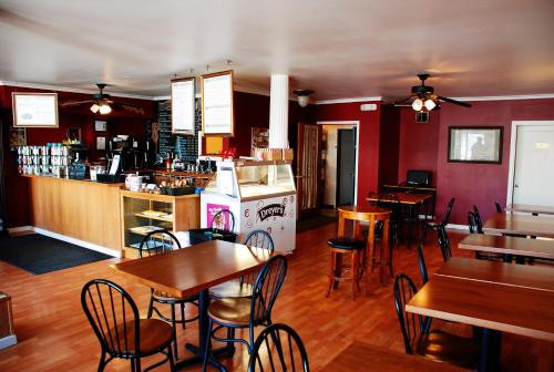 a restaurant with tables and chairs and a bar at Sauerdough Lodging in Seward