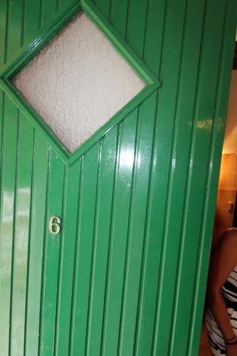 a green door with a window on top of it at House Dimitri Agios Georgios Pagoi Corfu in Agios Georgios Pagon