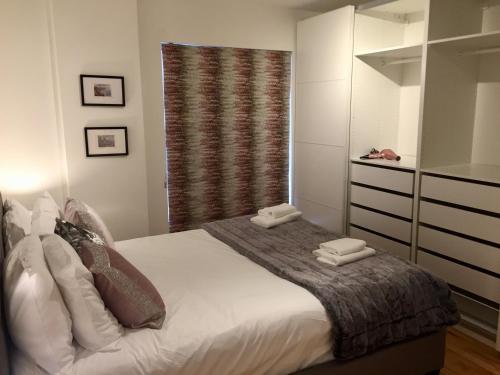 a bedroom with a bed with two towels on it at City Centre Belfast Free Parking in Belfast