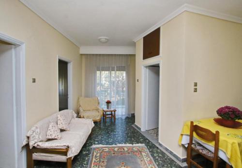 a living room with a couch and a table at Konstantina’s House in Paleo Tsifliki