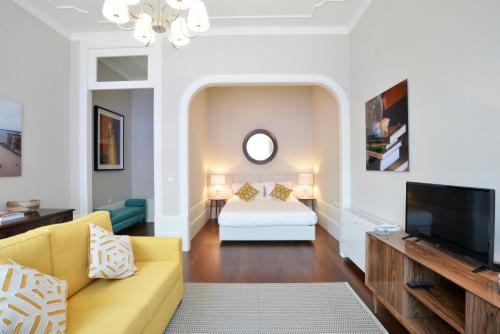 a living room with a bed and a tv at YOUROPO - Market in Porto
