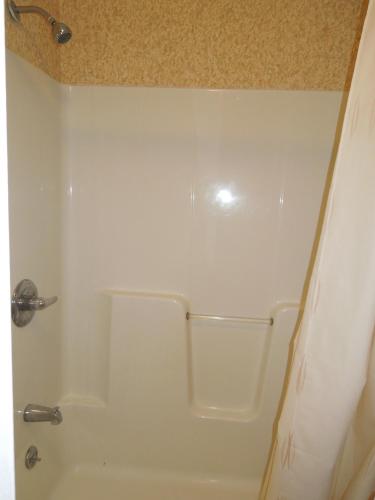 a white shower in a bathroom with a shower at Value Inn East Stroudsburg in Marshalls Creek