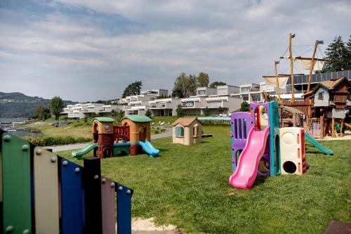 a playground with a bunch of play equipment in the grass at Apartment Słoneczny Gródek 38 in Gródek Nad Dunajcem