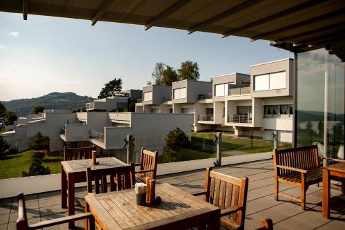 a patio with tables and chairs and a building at Apartment Słoneczny Gródek 38 in Gródek Nad Dunajcem
