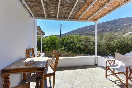 a table and chairs on a patio with a view at Giannakas Studios in Platis Yialos Sifnos