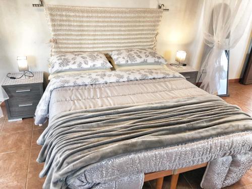 a large bed in a bedroom with two night stands at Trulli Caroli in Locorotondo