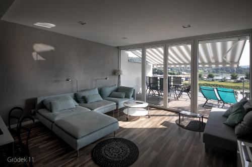 a living room with a couch and a table at Apartment Słoneczny Gródek 11 in Gródek Nad Dunajcem