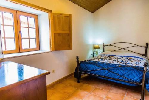 a bedroom with a bed and a window at "Casa Do Avô Patrício" Mountain Experience in Parada