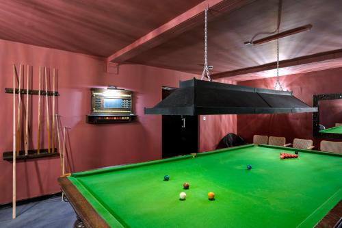 a pool table in a room with pink walls at Burgh Island Hotel in Bigbury on Sea