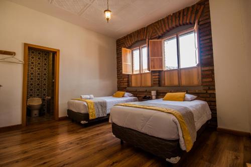 Кровать или кровати в номере San Rocke House Hotel