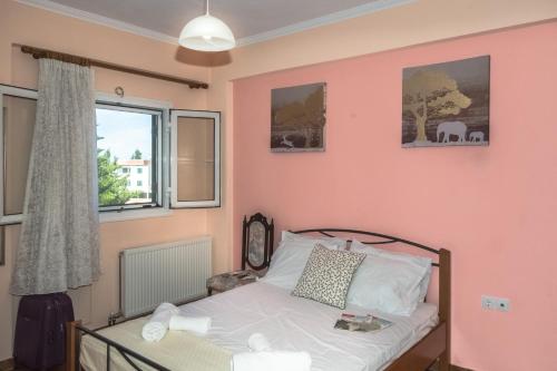 a bedroom with a bed and a window at Modern flat with beautiful views in south of Corfu in Lefkimmi