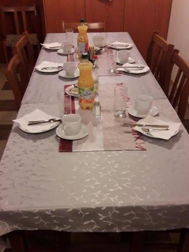 a long table with a white table cloth on it at Dorfwirtshaus Rauch in Eschabruck