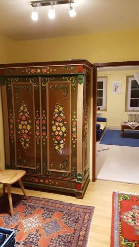 a large wooden cabinet in a room with a rug at Am-Berg Ferienwohnung in Bad kohlgrub in Bad Kohlgrub