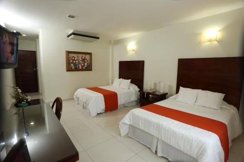 a hotel room with two beds and a flat screen tv at Hotel Marel in Poza Rica de Hidalgo