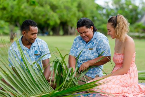 a man and two women looking at a plant at Yatule Resort & Spa in Natadola