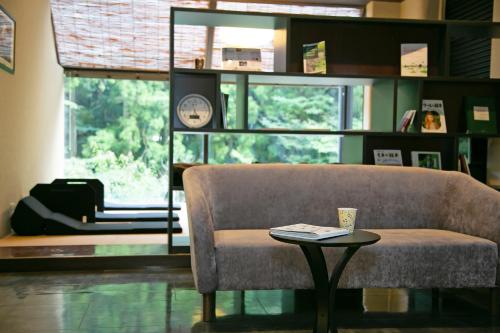 a living room with a couch and a table at Hakone Nanase formerly known as Manatei Hakone in Hakone