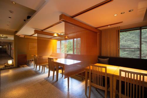 a dining room with wooden tables and chairs at Hakone Nanase formerly known as Manatei Hakone in Hakone