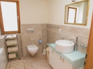 a bathroom with a sink and a toilet and a mirror at Crastuoglia 855-1 in Scuol