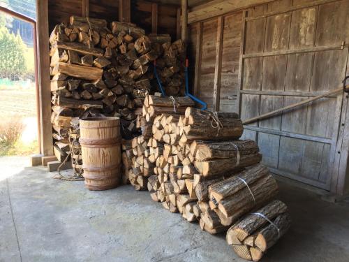 a stack of logs in front of a barn at Goemon Kyoto Japan in Kyoto