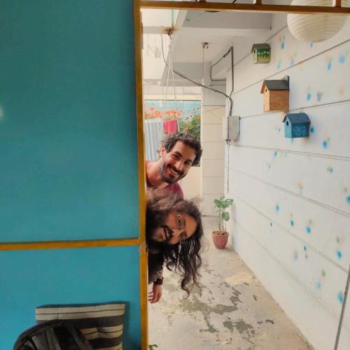 a man and a woman standing in a room at The Little Blue Window Hostel in Bengaluru