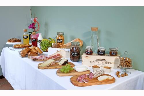 a table with different types of bread and other foods at Panoramic Villa Garassino - country rooms and fine restaurant in Treiso