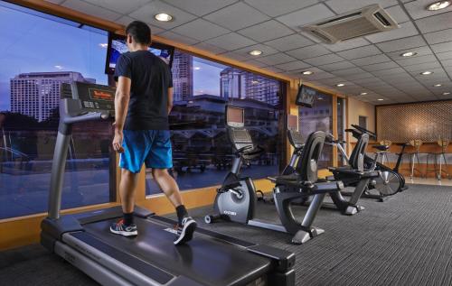 a man standing on a treadmill in a gym at Concorde Hotel Kuala Lumpur in Kuala Lumpur