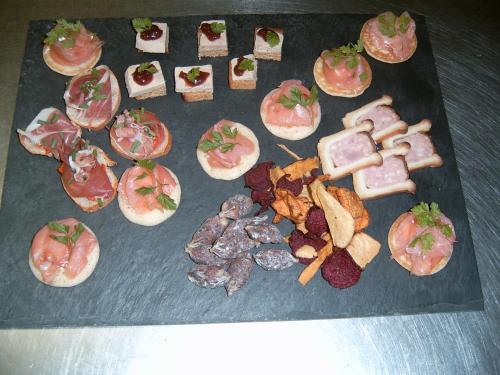a bunch of different types of food on a table at Hotel De La Gare in Sainte-Gauburge-Sainte-Colombe