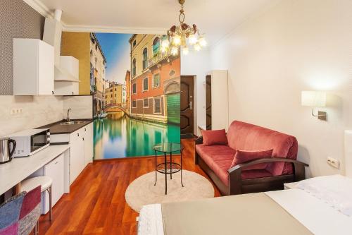 a kitchen and living room with a view of a canal at Deja Vu Apart-Hotel in Pyatigorsk