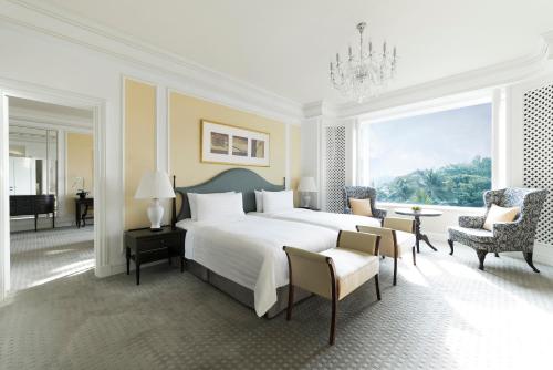 a bedroom with a large bed and a large window at Shangri-La Singapore in Singapore