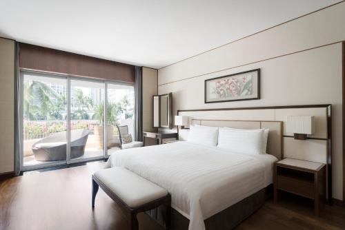 a bedroom with a large bed and a large window at Shangri-La Singapore in Singapore