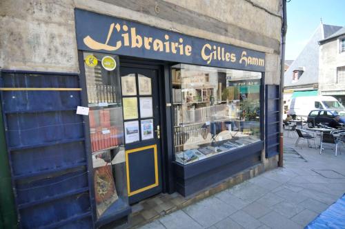 a store with a sign on the side of a building at Le Passage in La Charité-sur-Loire