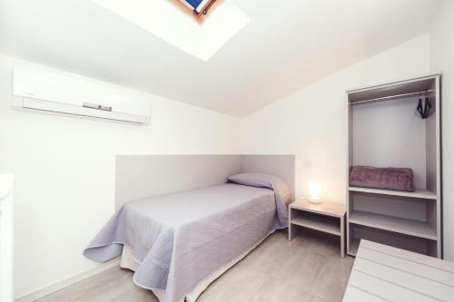 a small bedroom with a bed and a mirror at Luccainn in Lucca
