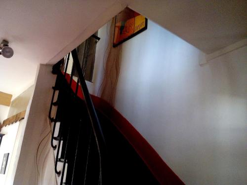 a stairwell with a bunch of black and red clothing at Marie-Claire la grillade in Briare