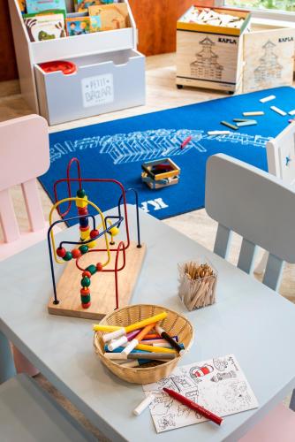 a white table with a basket of stationery on it at Aparthotel Adagio Paris Malakoff Chatillon in Malakoff