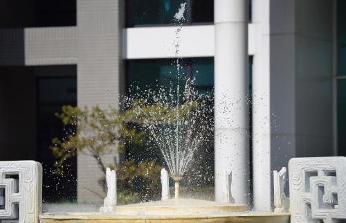 a water fountain in front of a building at Sun Moon Lake Teachers' Hostel in Yuchi