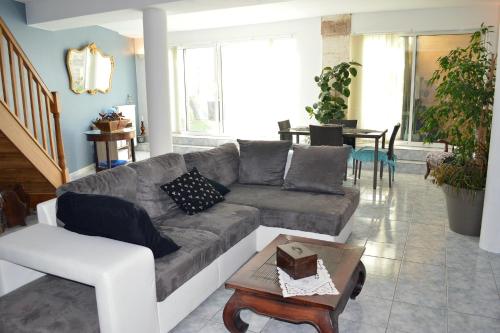 a living room with a couch and a table at Les remparts d'Angoulême in Angoulême