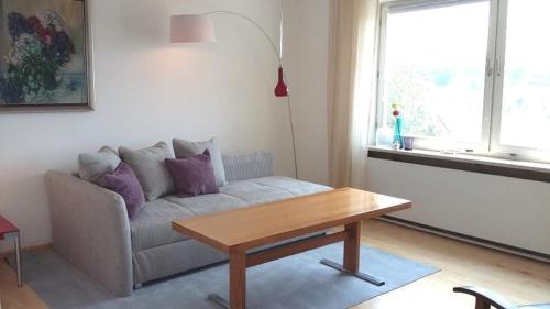 a living room with a couch and a table at Ferienwohnung Hofgarten in Ansbach