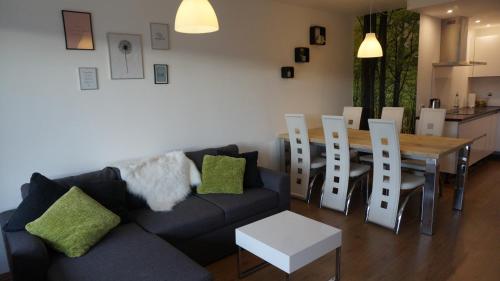 ein Wohnzimmer mit einem Sofa, einem Tisch und Stühlen in der Unterkunft Appartement Familie Willems Winterberg 2 in Winterberg