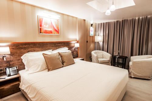 a hotel room with a bed and a chair at Amina Residency in Male City