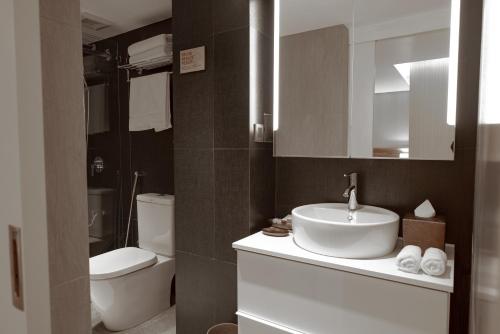 a bathroom with a sink and a toilet at Amina Residency in Male City