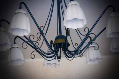 a chandelier hanging from a wall with four lights at Cà Fernanda in Fiesso Umbertiano