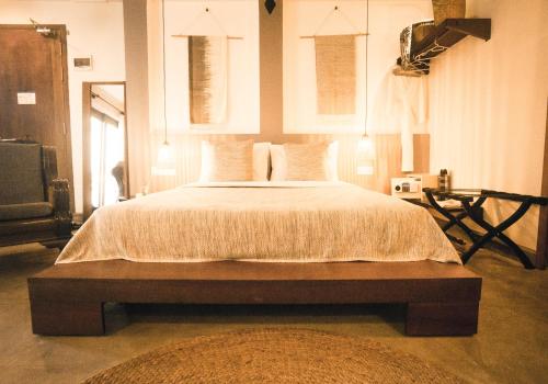a bedroom with a large bed with white sheets and pillows at iRoHa Garden Hotel & Resort in Phnom Penh