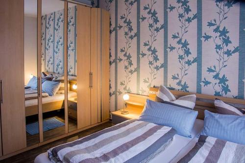 a bedroom with two beds and a mirror at Lilie in Langen