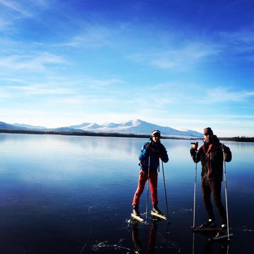 two people are standing on skis in the water at Hotell Karolinen Åre in Åre
